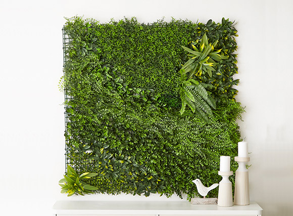 Lush green artificial plant panel used like art 